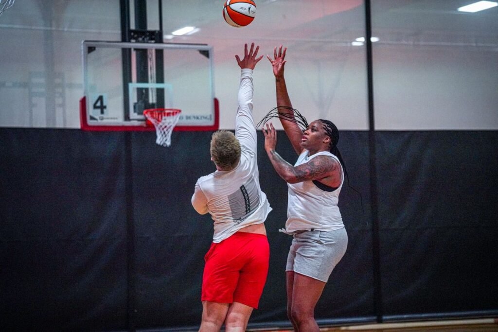 Rachel shooting a contested layup during basketball training.